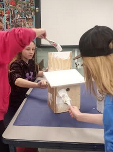 AMS’s students building birdhouses. 